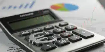 Símbolo del euro sobre una calculadora, gráficos económicos de fondo