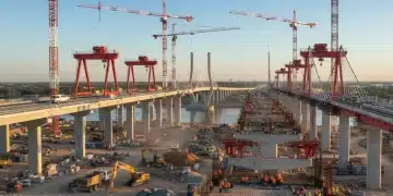 Construction workers and heavy machinery building new federal infrastructure projects, symbolizing job creation and economic growth.